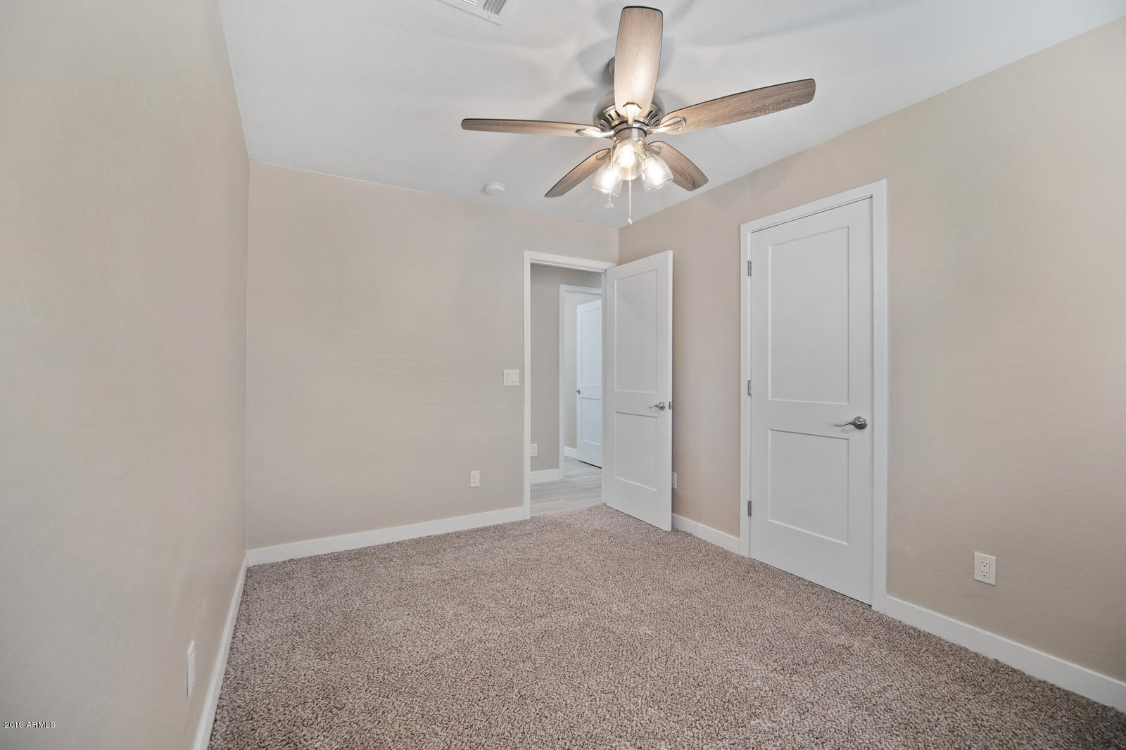 3351 North Randolph Road Phoenix, AZ 85014 - Photo 28 of 47 a view of an empty room and a chandelier fan