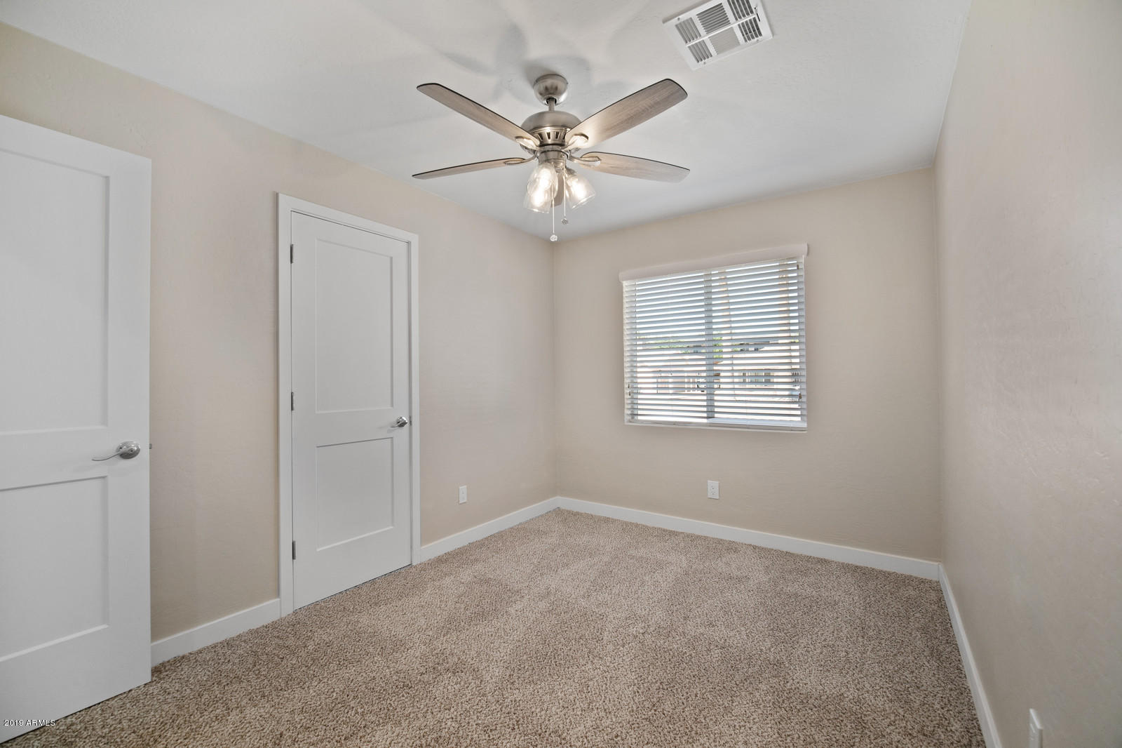 3351 North Randolph Road Phoenix, AZ 85014 - Photo 29 of 47 an empty room with windows and fan