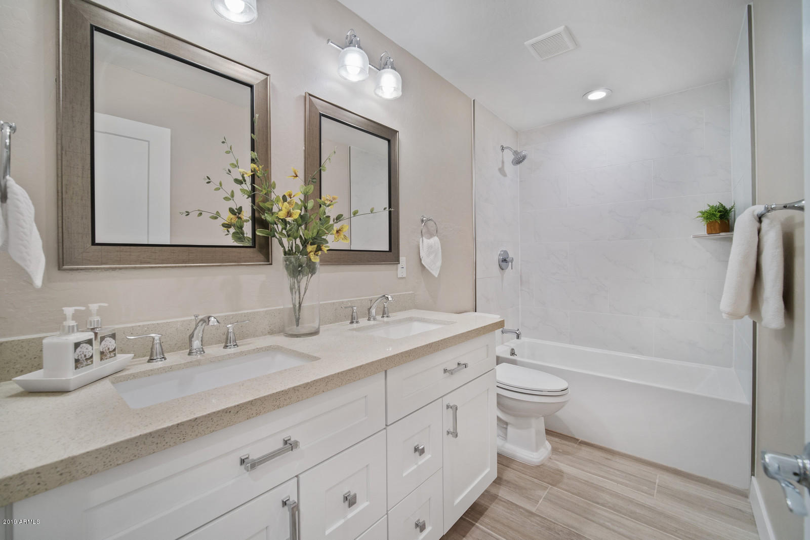 3351 North Randolph Road Phoenix, AZ 85014 - Photo 30 of 47 a bathroom with a granite countertop sink a toilet and a bathtub