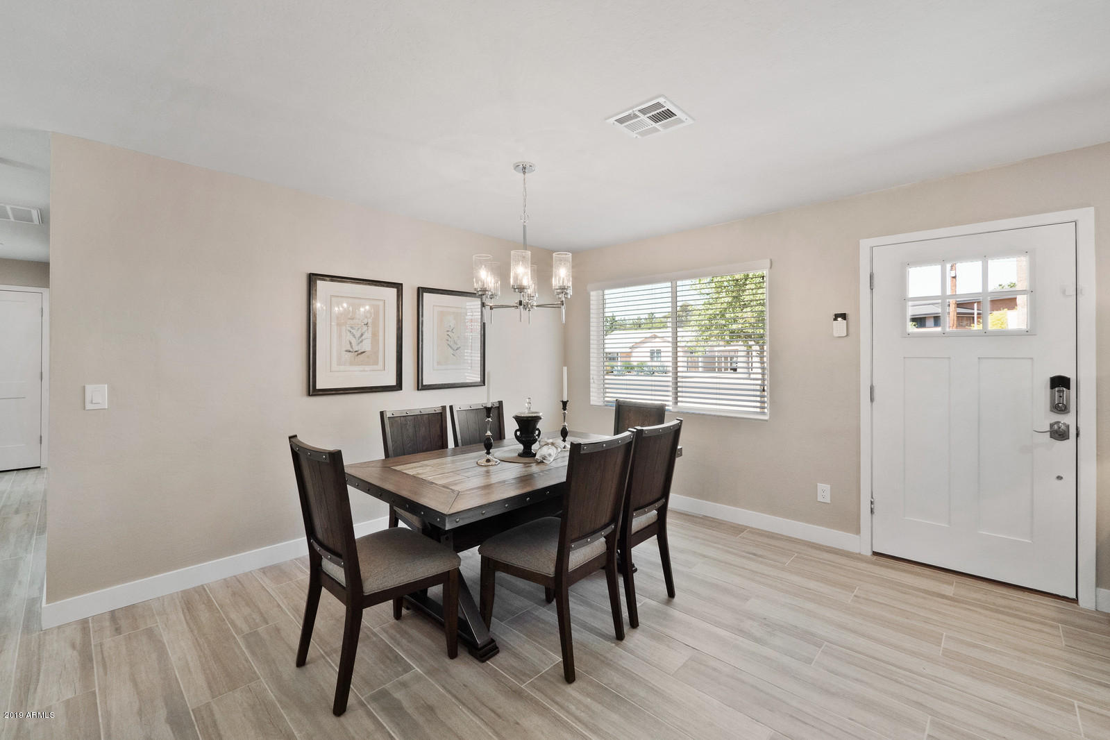 3351 North Randolph Road Phoenix, AZ 85014 - Photo 3 of 47 a view of a dining room with furniture window and wooden floor