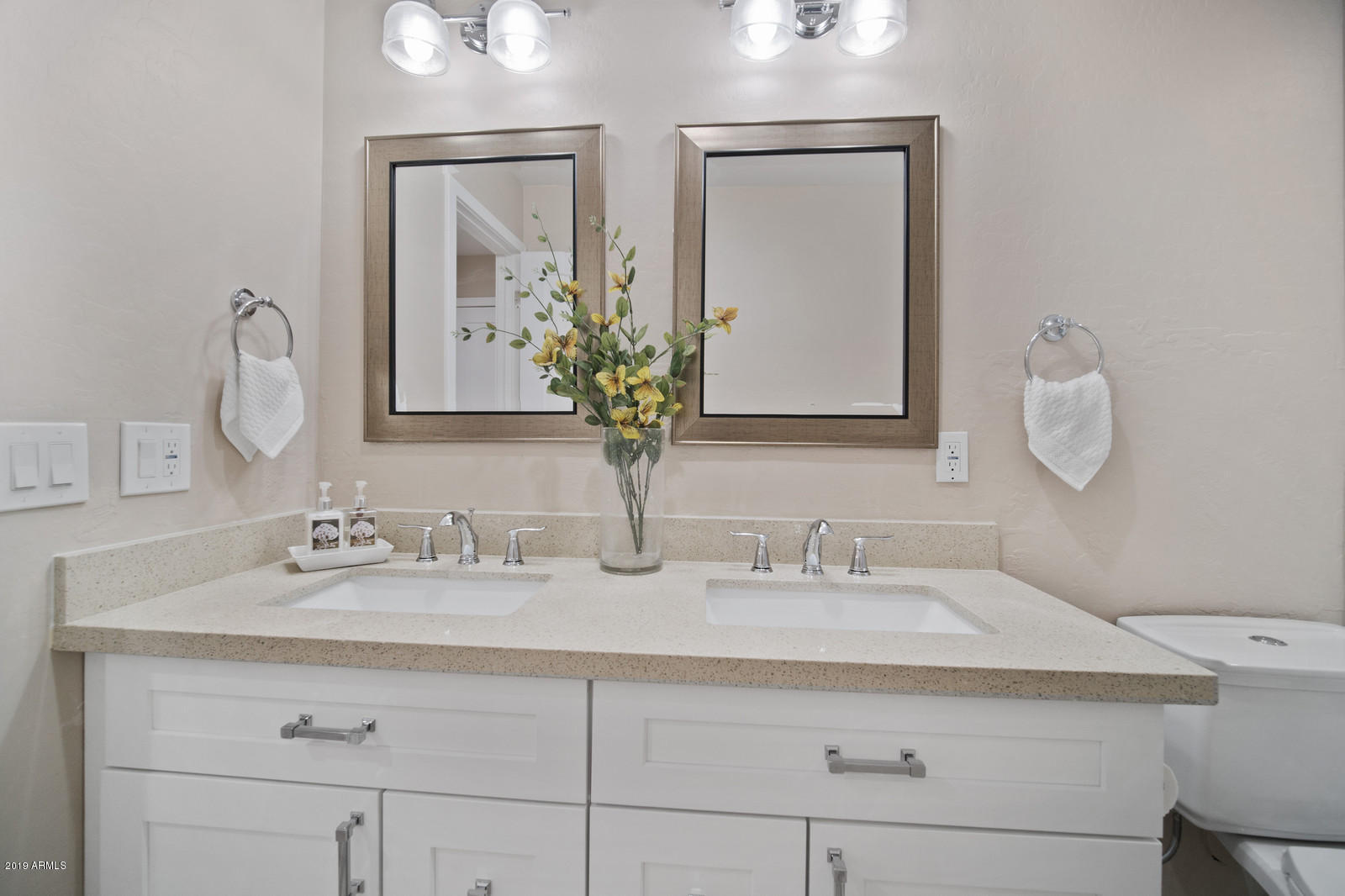 3351 North Randolph Road Phoenix, AZ 85014 - Photo 31 of 47 a bathroom with double vanity sinks and a mirror