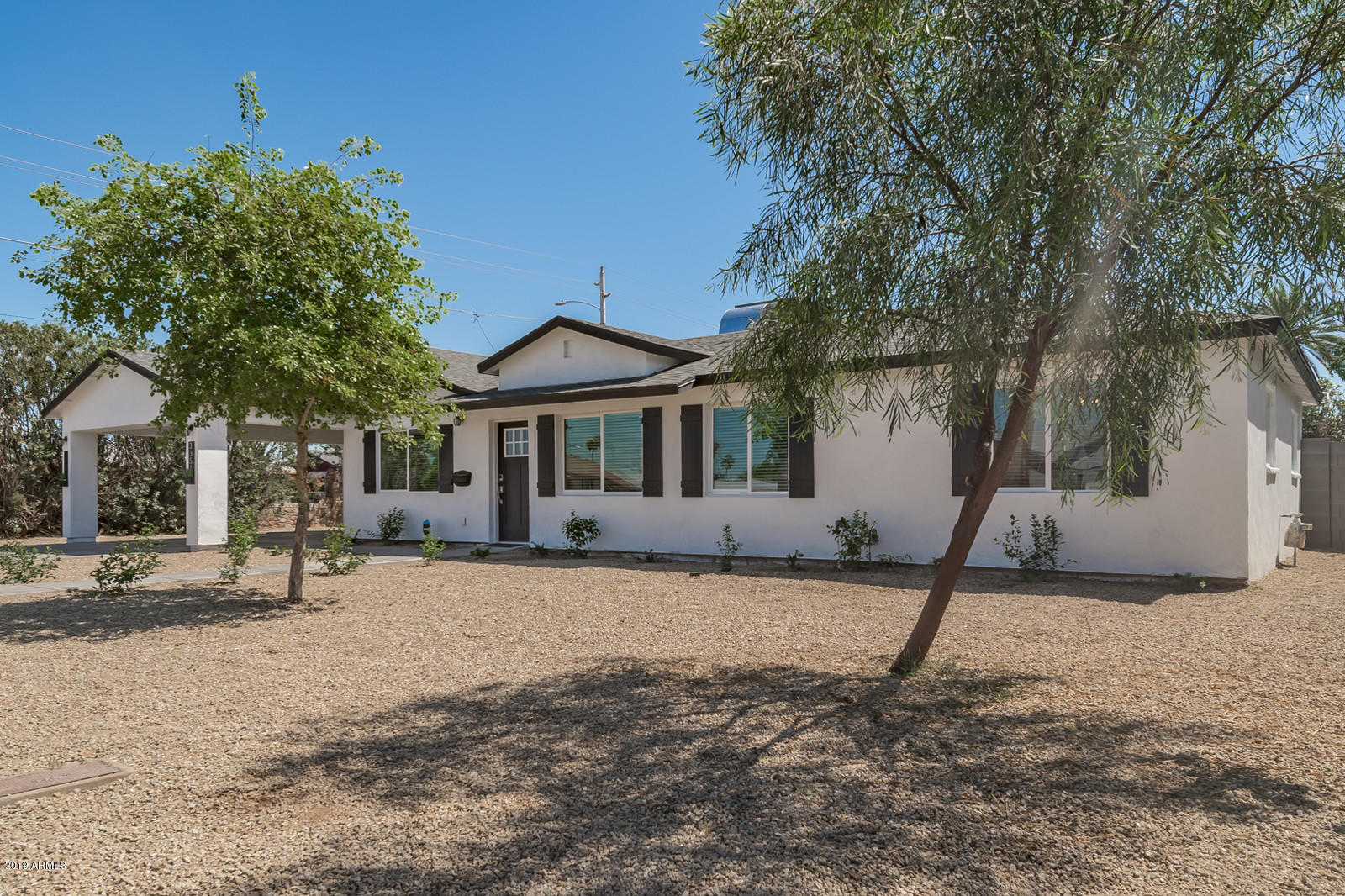 3351 North Randolph Road Phoenix, AZ 85014 - Photo 35 of 47 a white house that has a tree in front of it
