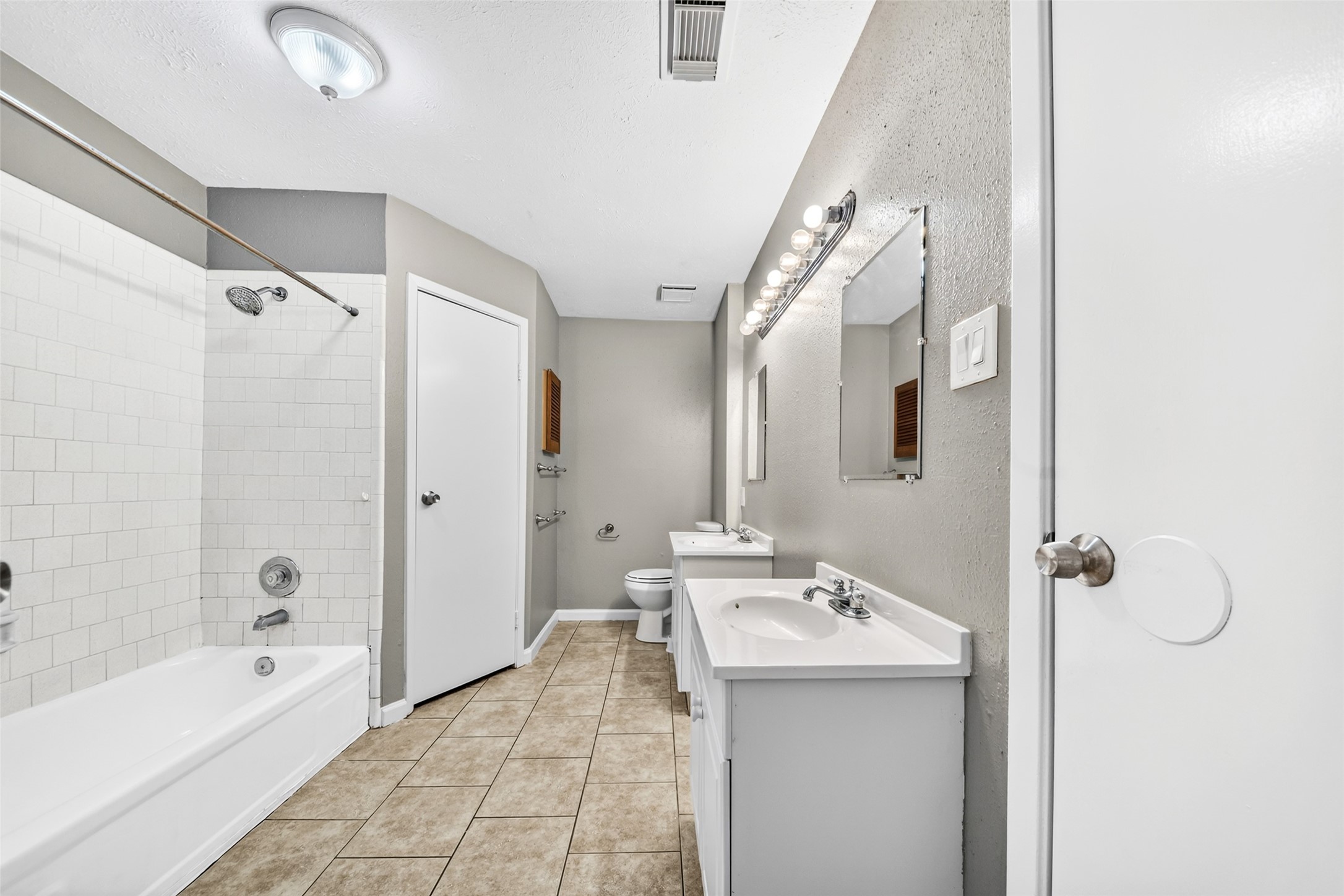 3119 Oak Rock Spring, TX 77373 - Photo 6 of 25 a bathroom with a granite countertop sink a mirror and a bathtub