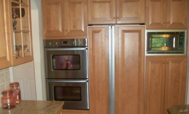 186 Heyer Road Nazareth, PA 18064 - Photo 15 of 49 a kitchen with granite countertop a refrigerator stove and cabinets