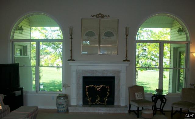 186 Heyer Road Nazareth, PA 18064 - Photo 9 of 49 a living room with a fireplace and a large window