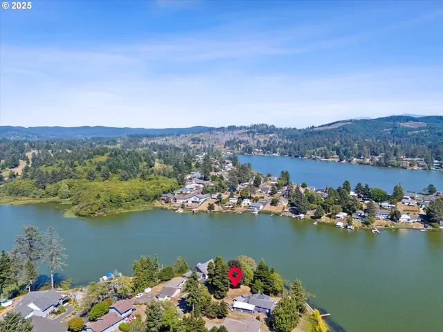 an aerial view of a houses with ocean view