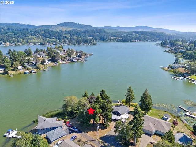 an aerial view of a house with a lake view