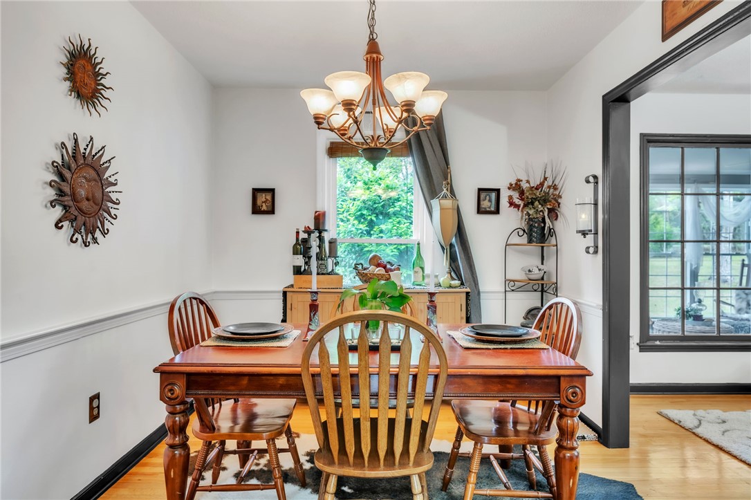 722 Lay Bridge Road Central, SC 29630 - Photo 10 of 32 This dining area features hardwood flooring, a charming chandelier, and crown molding.