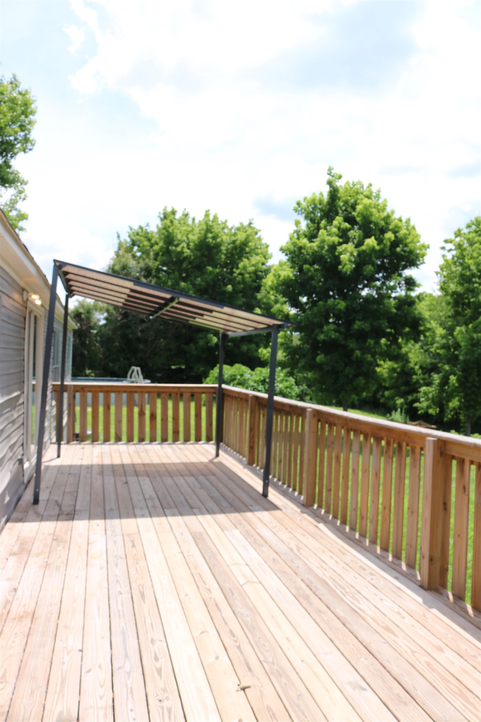 229 Coats Road Brighton, TN 38011 - Photo 9 of 14 Expansive wood deck with natural wood railing, featuring a contemporary pergola structure