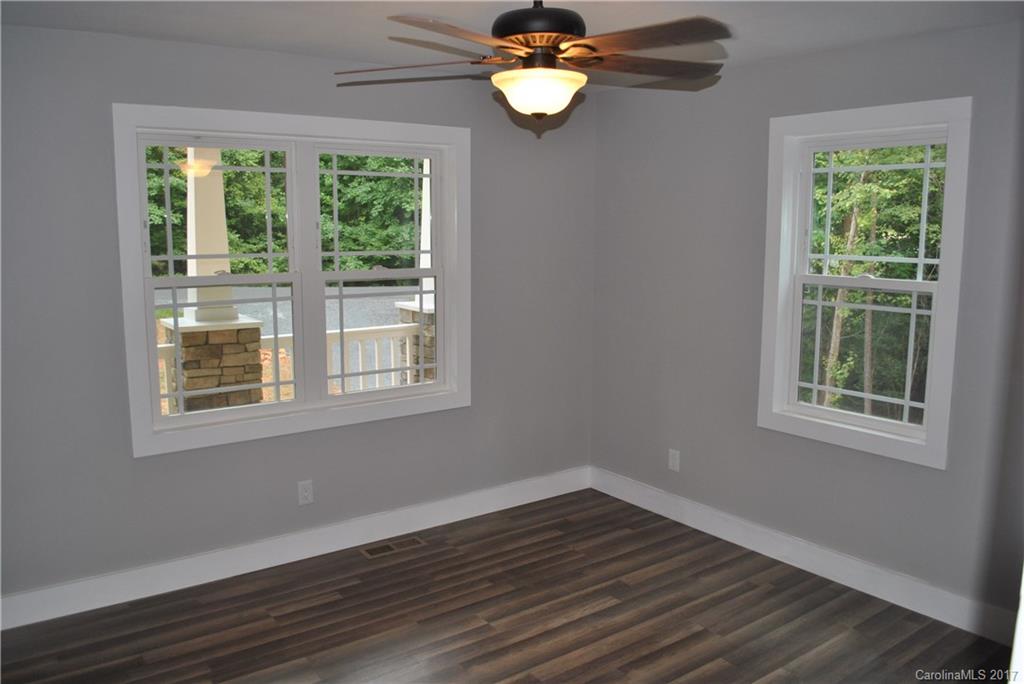 335 Creswell Road, Unit 1011 Mount Gilead, NC 27306 - Photo 12 of 18 a view of an empty room with wooden floor and a window