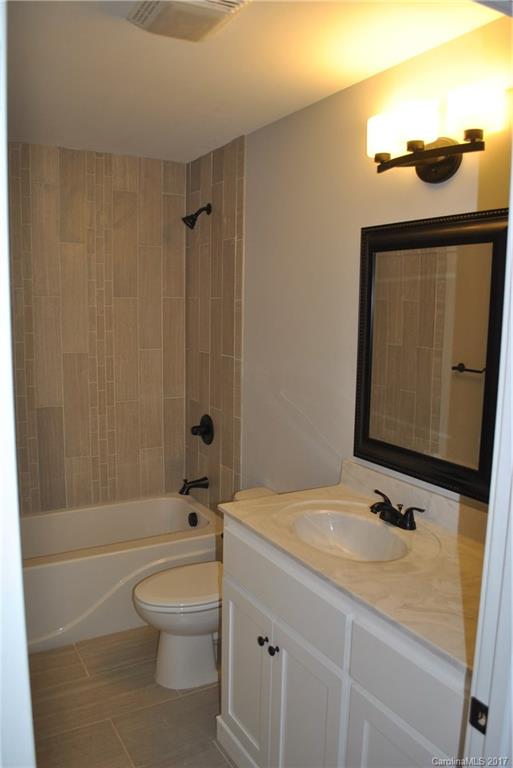 335 Creswell Road, Unit 1011 Mount Gilead, NC 27306 - Photo 14 of 18 a bathroom with a sink a toilet and shower