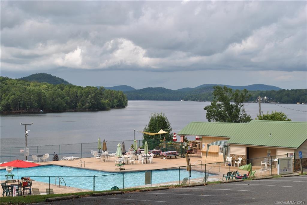 335 Creswell Road, Unit 1011 Mount Gilead, NC 27306 - Photo 18 of 18 a view of a lake with couches under an umbrella