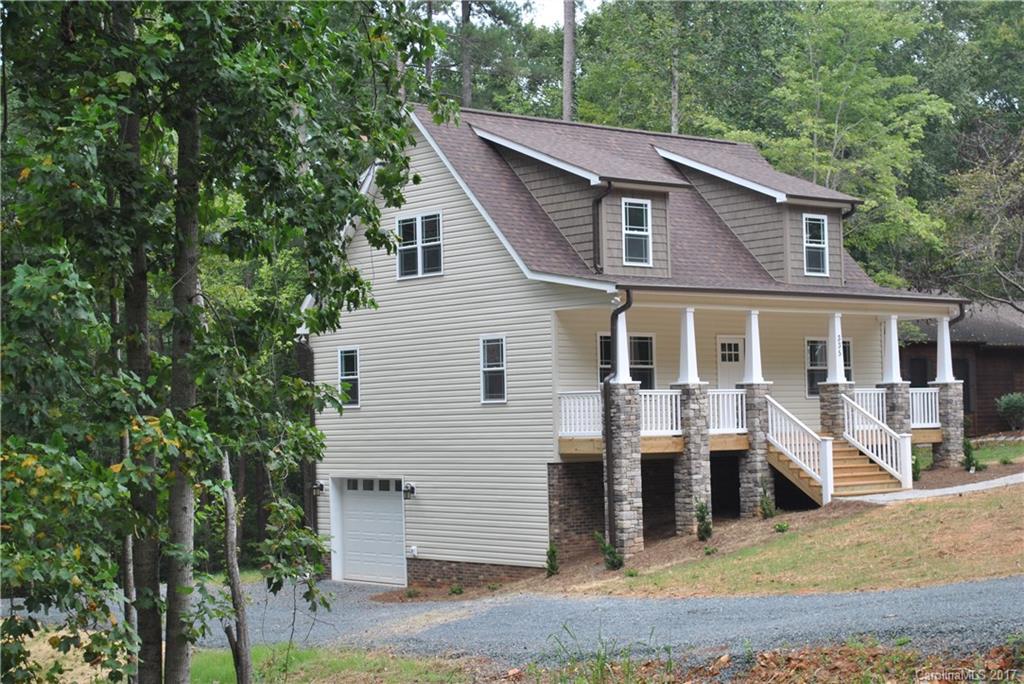 335 Creswell Road, Unit 1011 Mount Gilead, NC 27306 - Photo 3 of 18 a view of a house with a yard and lawn chairs