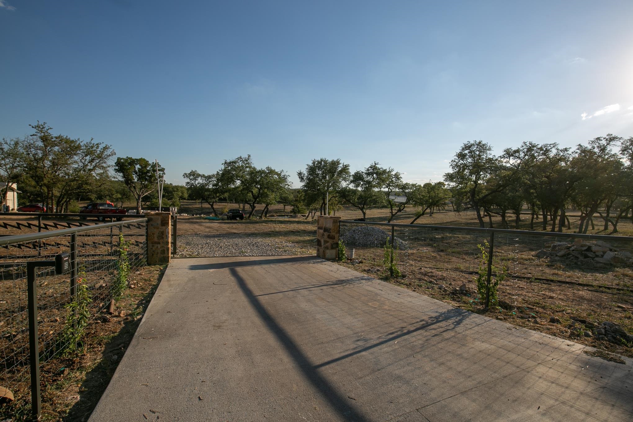 a view of a pathway with a wrought fence