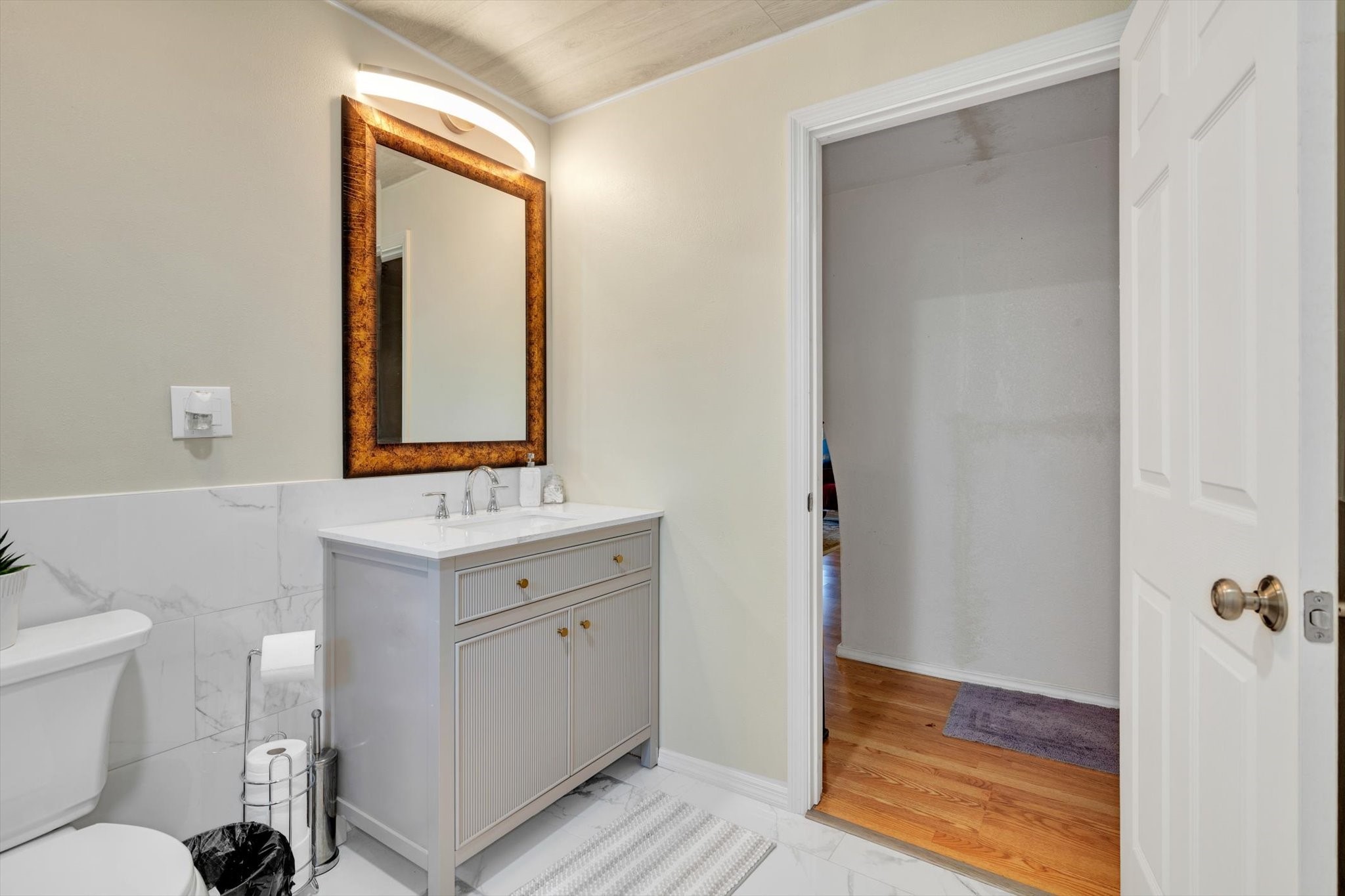 90 County Road 2852 Cleveland, TX 77327 - Photo 21 of 50 a bathroom with a toilet sink and mirror