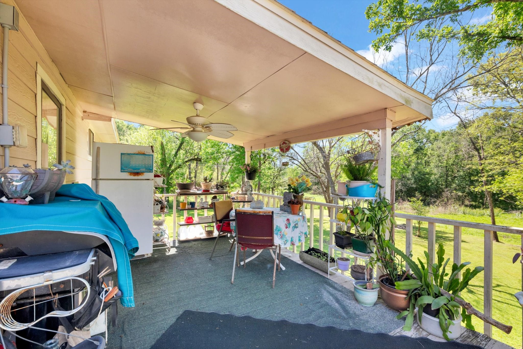 90 County Road 2852 Cleveland, TX 77327 - Photo 35 of 50 a patio with table and chairs and potted plants