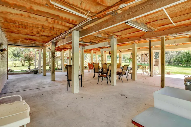 a view of a house with a yard and sitting area