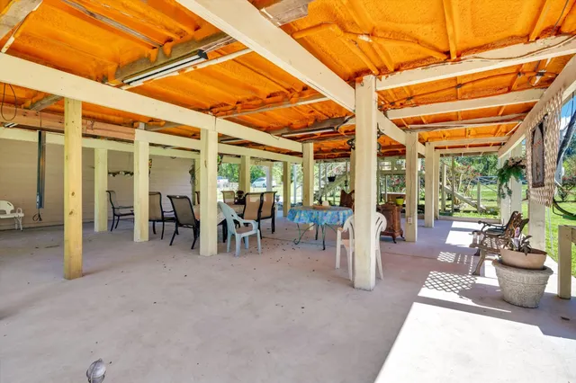 a view of a house with a big yard and large trees