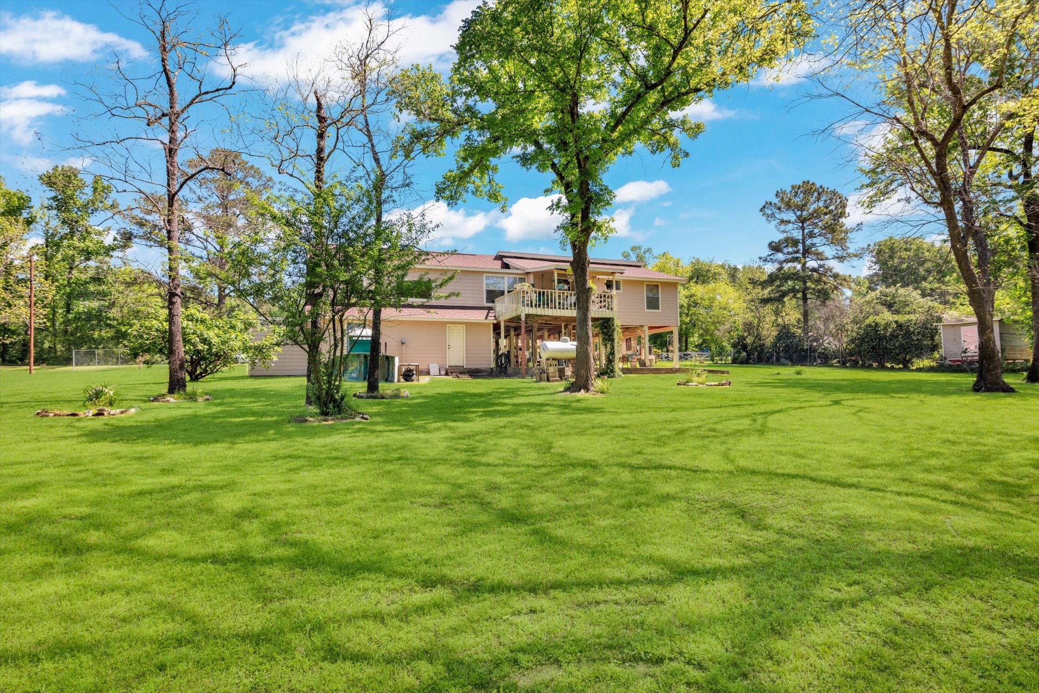 90 County Road 2852 Cleveland, TX 77327 - Photo 43 of 50 a view of a house with a big yard
