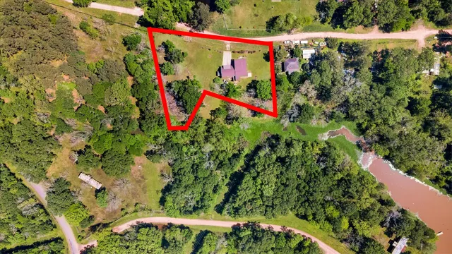 an aerial view of a houses with a yard