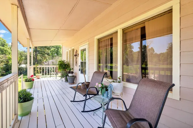 a view of balcony with wooden floor