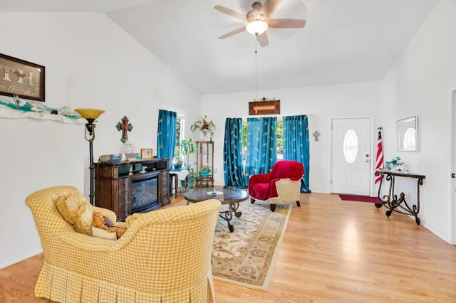 a living room with furniture a chandelier and a dining table