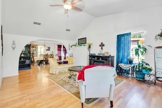 a living room with furniture and a chandelier