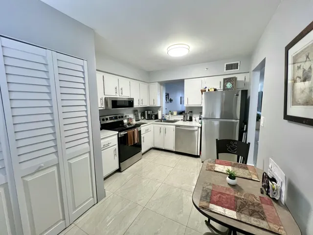 a kitchen with a refrigerator a stove top oven a sink and dishwasher
