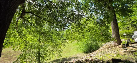 a view of a dining room with furniture wooden floor and a large window