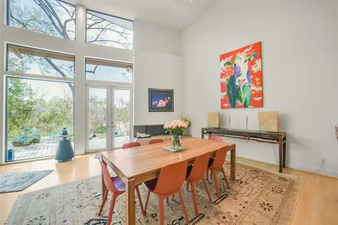 a living room with furniture and a floor to ceiling window