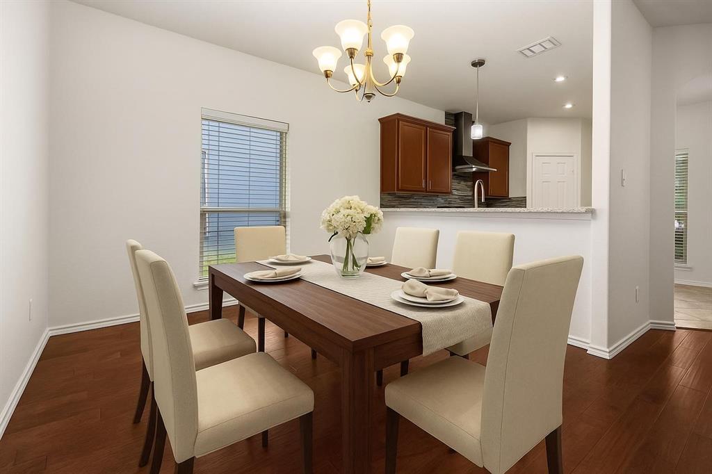 10969 Colonial Heights Lane Fort Worth, TX 76179 - Photo 12 of 34 a view of a dining room with furniture and wooden floor