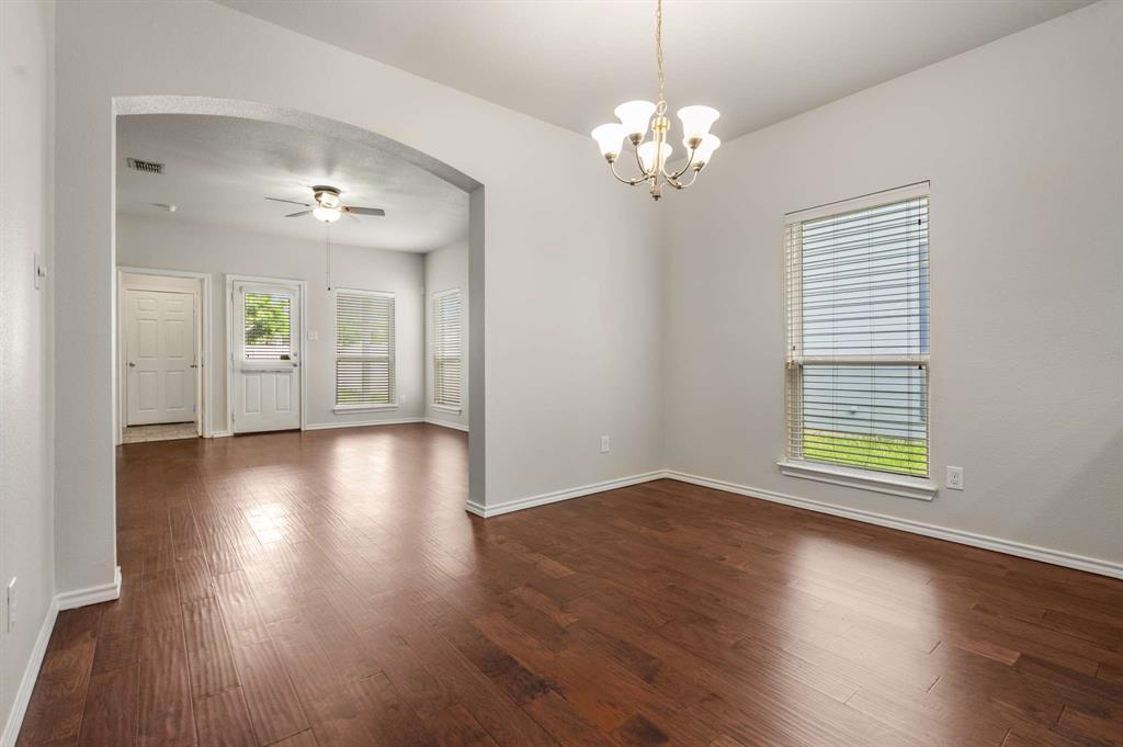 10969 Colonial Heights Lane Fort Worth, TX 76179 - Photo 14 of 34 a view of an empty room with wooden floor and a window