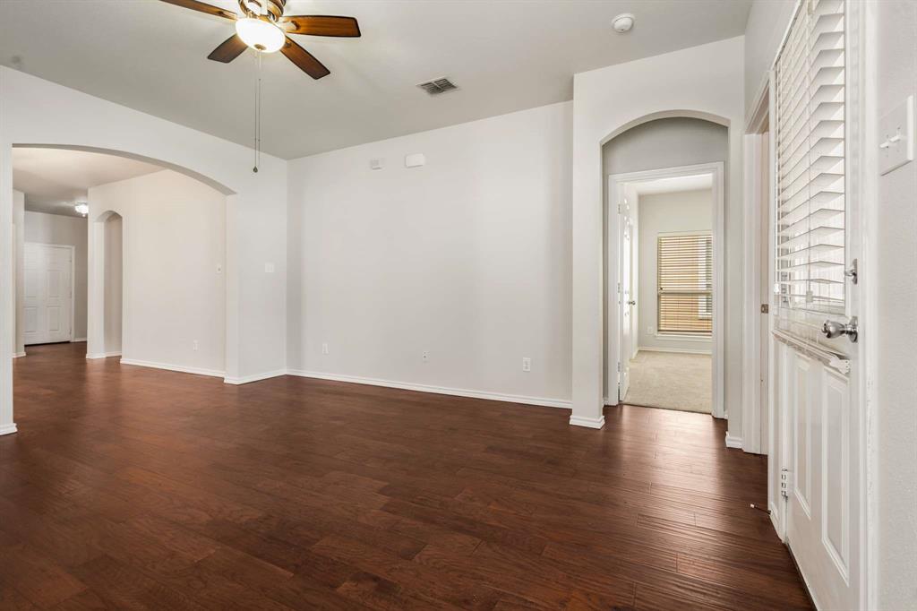 10969 Colonial Heights Lane Fort Worth, TX 76179 - Photo 17 of 34 a view of a room with wooden floor fan and windows