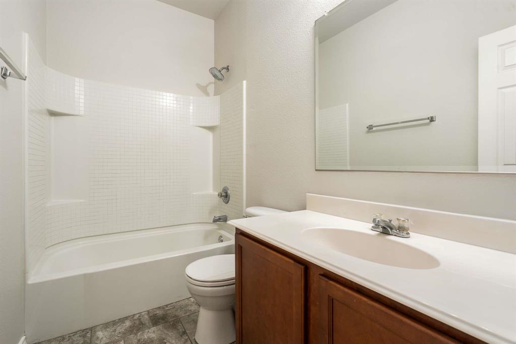 10969 Colonial Heights Lane Fort Worth, TX 76179 - Photo 18 of 34 a bathroom with a sink a toilet and a bathtub
