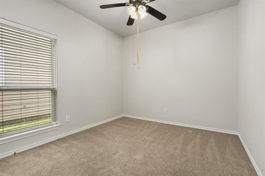 10969 Colonial Heights Lane Fort Worth, TX 76179 - Photo 19 of 34 a view of an empty room with a window