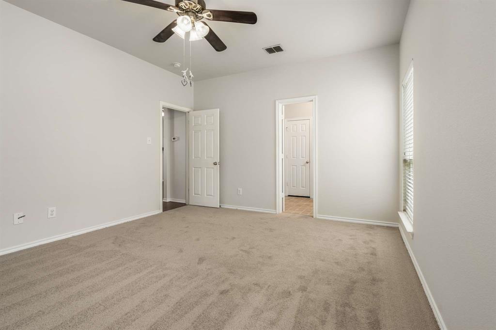 10969 Colonial Heights Lane Fort Worth, TX 76179 - Photo 25 of 34 an empty room with chandelier fan and closet