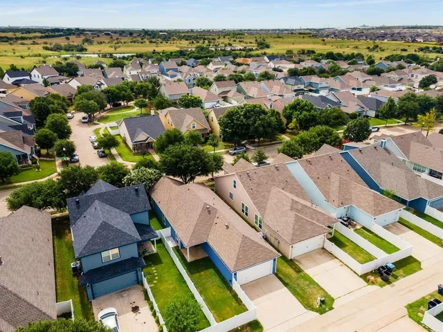 an aerial view of residential houses with outdoor space