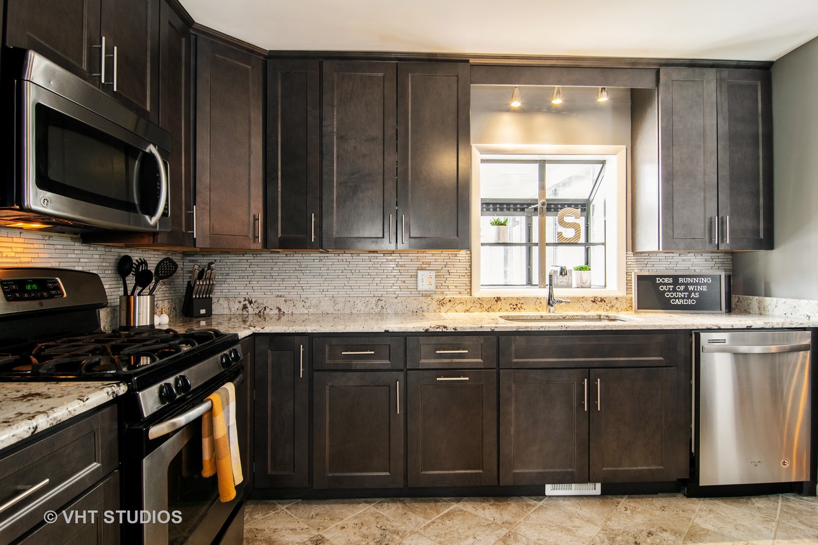 27-w084 Jewell Road Winfield, IL 60190 - Photo 4 of 16 a kitchen with stainless steel appliances granite countertop a stove a sink and a microwave