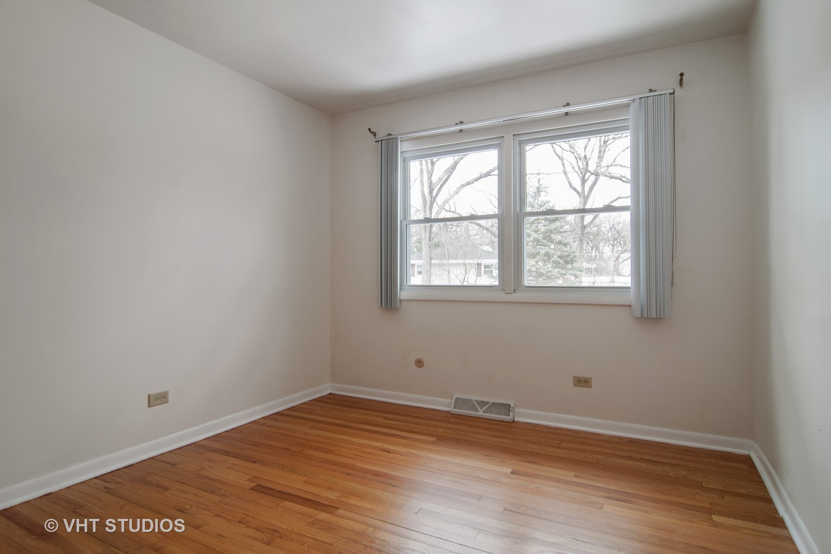 27-w084 Jewell Road Winfield, IL 60190 - Photo 8 of 16 an empty room with wooden floor and windows