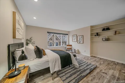 a bedroom with a bed and wooden floor