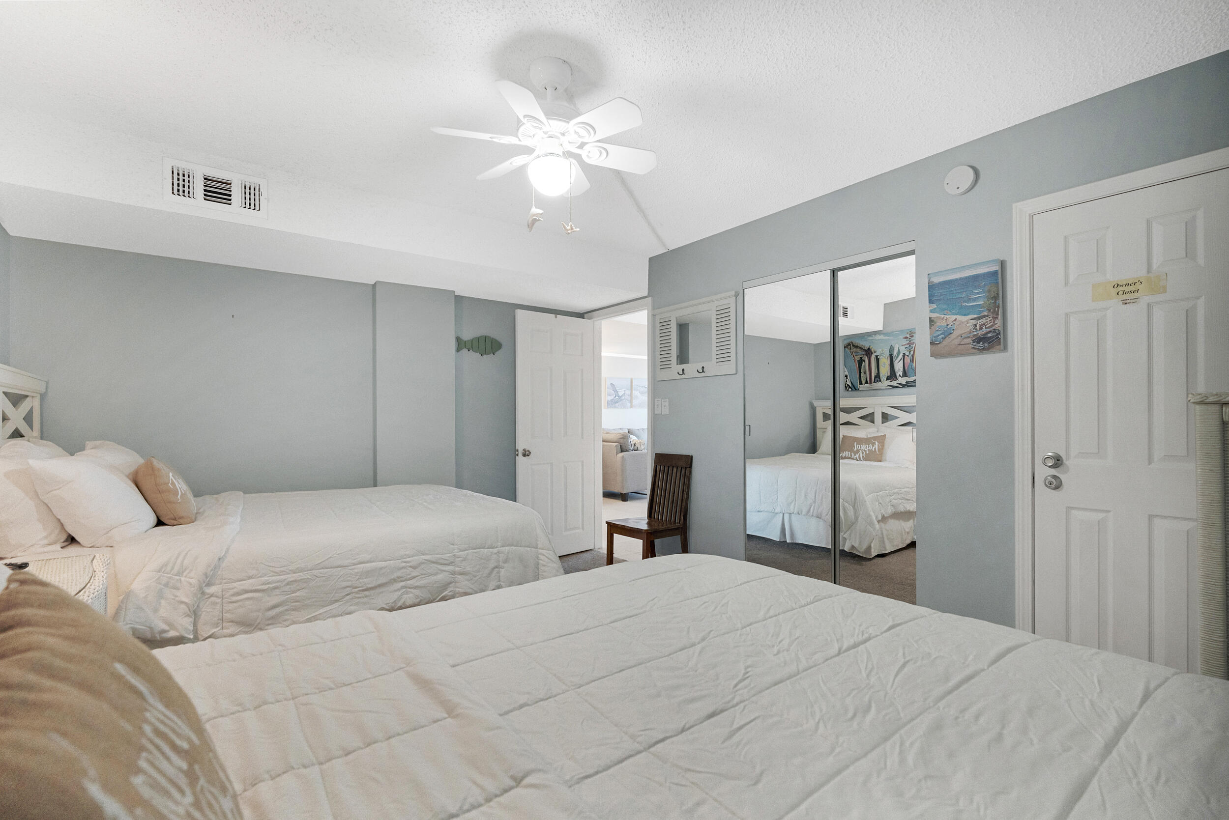 30 Moreno Point Road, Unit 303A Destin, FL 32541 - Photo 12 of 34 a bedroom with a large bed and a chandelier