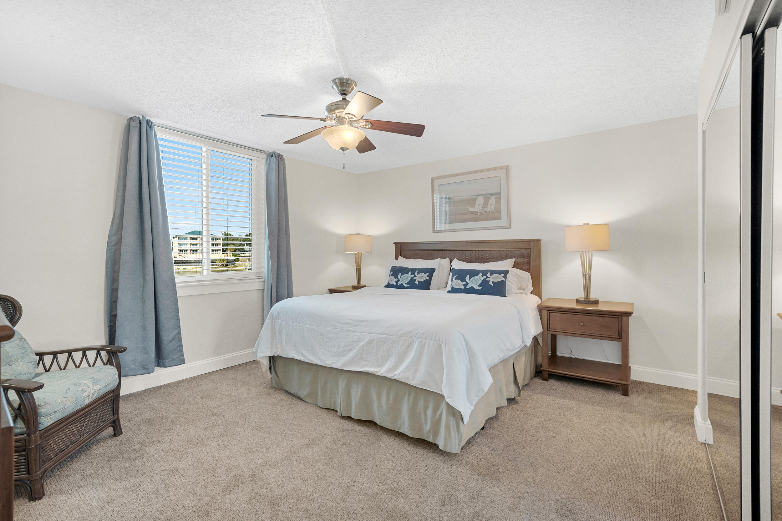 30 Moreno Point Road, Unit 303A Destin, FL 32541 - Photo 15 of 34 a bedroom with a bed and a night stand