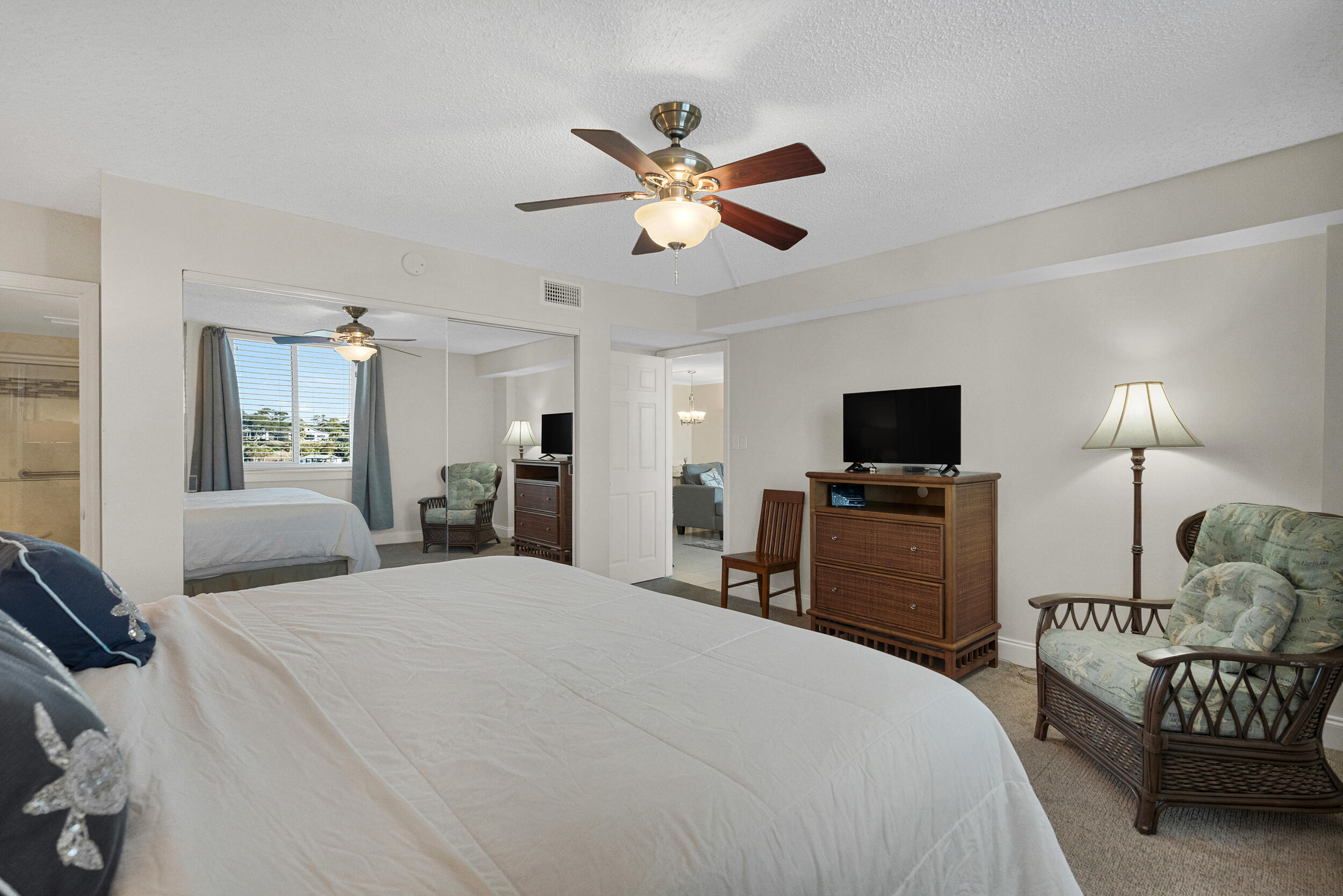 30 Moreno Point Road, Unit 303A Destin, FL 32541 - Photo 17 of 34 a bedroom with a bed and a tv