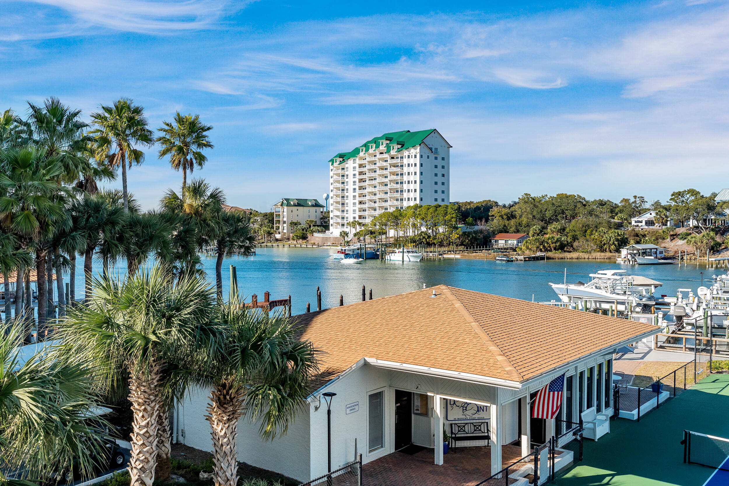 30 Moreno Point Road, Unit 303A Destin, FL 32541 - Photo 22 of 34 a view of a lake with a table and chairs