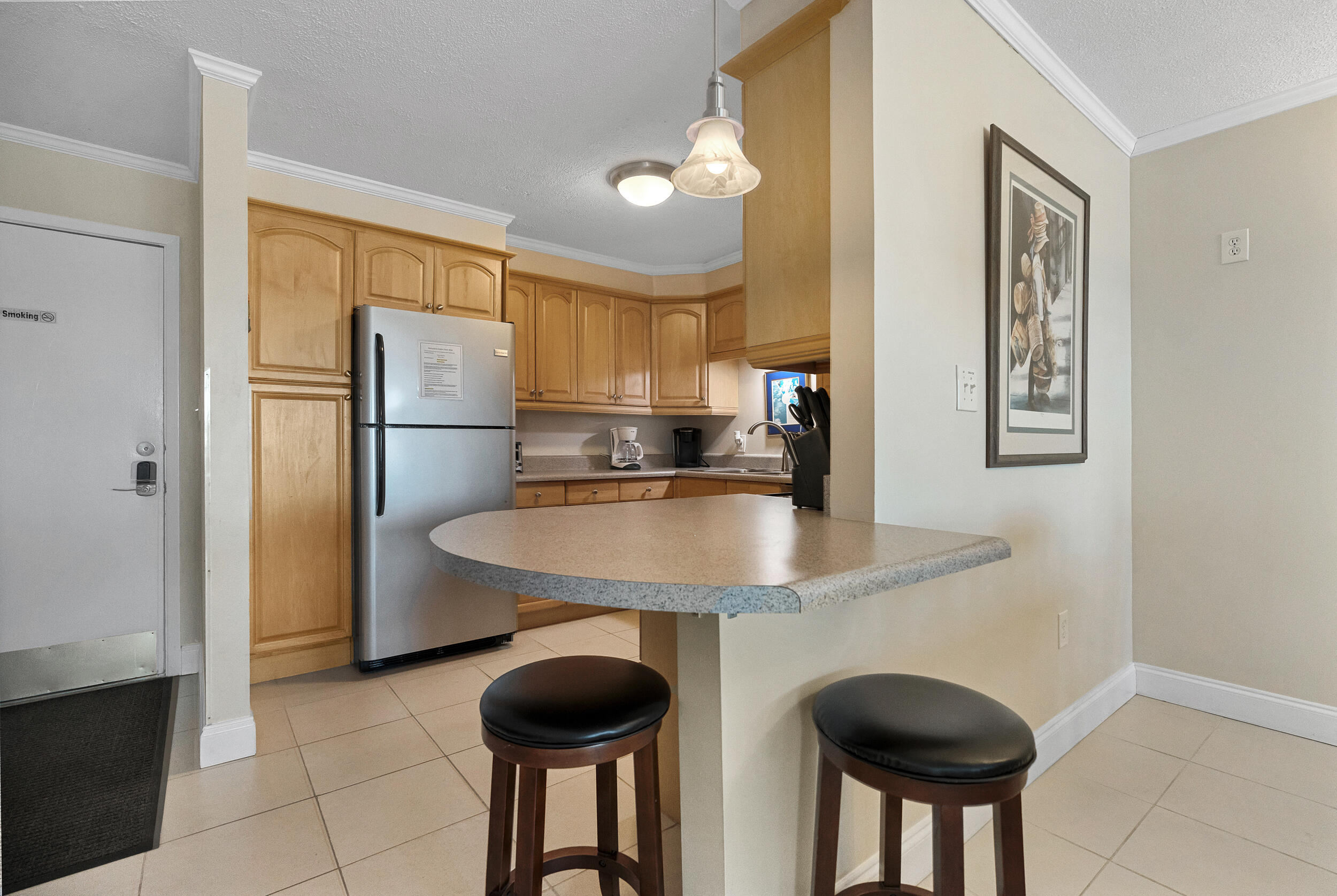 30 Moreno Point Road, Unit 303A Destin, FL 32541 - Photo 6 of 34 a kitchen with granite countertop a sink a refrigerator a stove and a cabinets