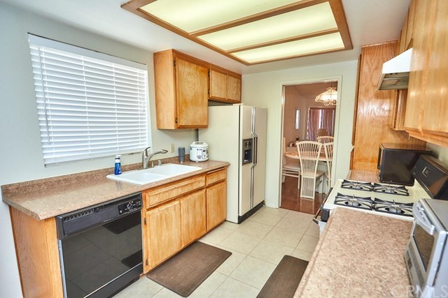 471 Silverado Street Barstow, CA 92311 - Photo 16 of 43 a kitchen with stainless steel appliances kitchen island granite countertop a sink stove and refrigerator