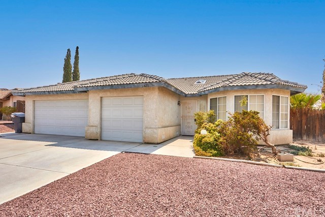 471 Silverado Street Barstow, CA 92311 - Photo 2 of 43 a front view of a house with a yard and garage