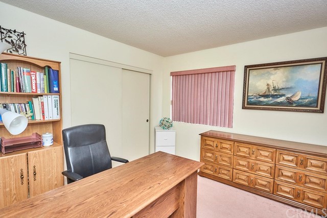 471 Silverado Street Barstow, CA 92311 - Photo 21 of 43 a bedroom with a bed and wooden floor