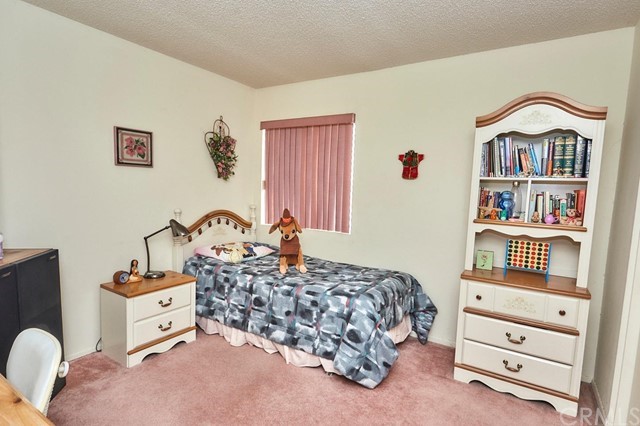 471 Silverado Street Barstow, CA 92311 - Photo 25 of 43 a bedroom with a bed and a dresser