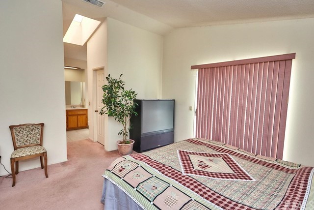 471 Silverado Street Barstow, CA 92311 - Photo 28 of 43 a bedroom with a bed and a potted plant